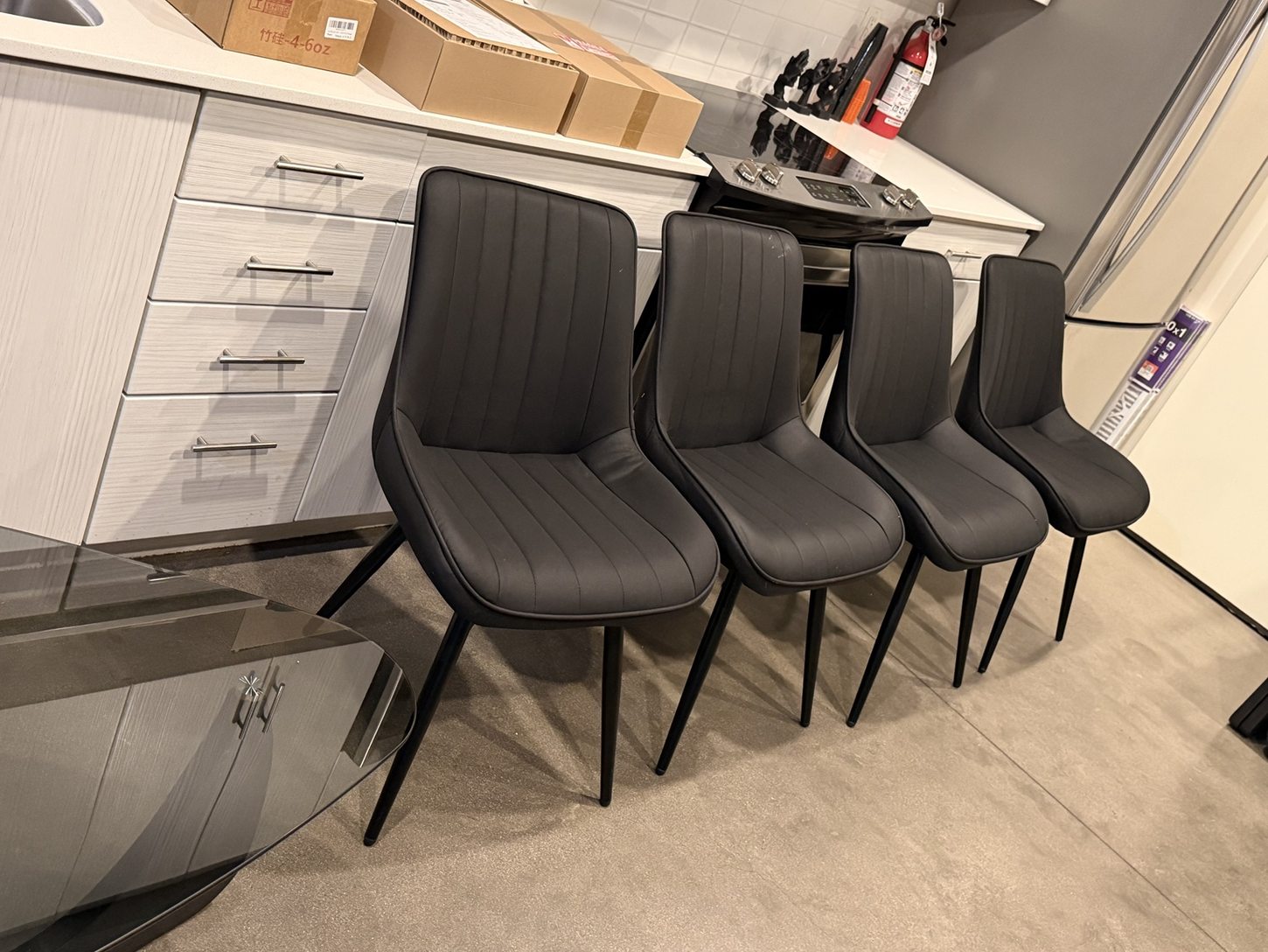 Four matching black upholstered chairs assembled by BoxBuilt