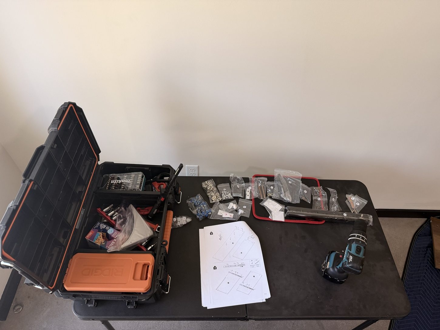 Organized hardware and instruction manuals on a folding work table